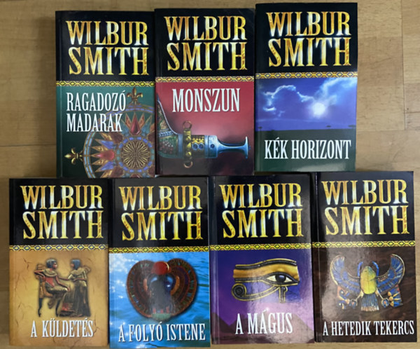 Wilbur Smith - 7 db Wilbur Smith reg�ny - A foly� istene, A k�ldet�s, A m�gus, A hetedik tekercs, Ragadoz� madarak, Monszun, K�k horizont