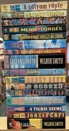 Wilbur Smith - 16 db Wilbur Smith k�tet: A s�lyom r�pte, Aranyb�nya, �gi sas, Mennyd�rg�s, Amikor az oroszl�n zab�l, Az angyalok zokognak, Gy�m�ntvad�szok, Elef�ntsirat�, �hes ak�r a tenger, Arany r�ka, A bossz�, Els�t�t�lt nap, Most kell megha